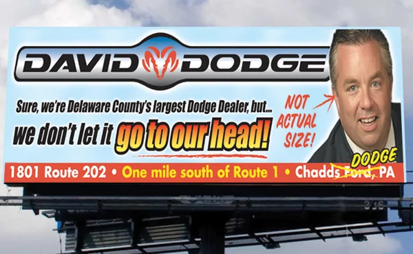 David Dodge billboard with a portrait photo and the line: Sure, we're Delaware County's largest Dodge dealer, but we don't let it go to our head