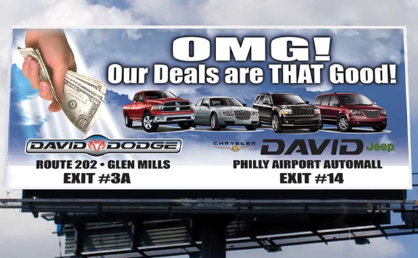 David Dodge and David Jeep billboard: OMG! Our deals are THAT good, with a hand full of cash and a row of trucks